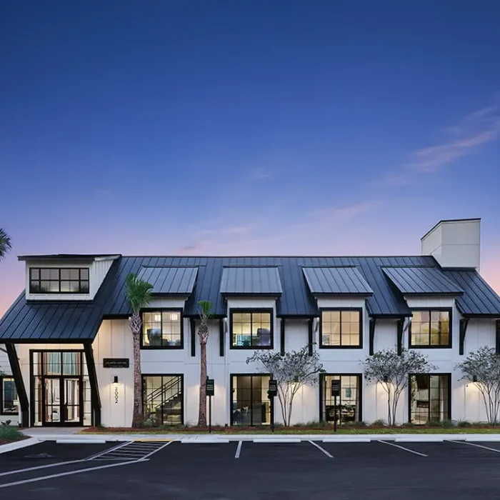 2 story building at twilight with palm trees